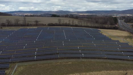 Aerial-Solar-Farm-Panels-Reveal-to-Mountains
