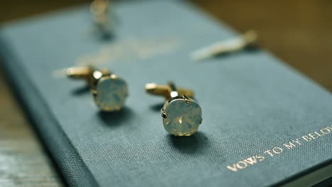 Gold-cufflinks-rotate-on-a-white-stand-close-up