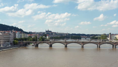 Gothic-arched-bridges,-the-Vltava-River,-reveal-the-beautiful-medieval-city-of-Prague,-aerial