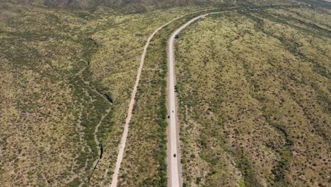 Remote-long-road-with-cars-from-above-in-arid-desert-landscape,-Argentina