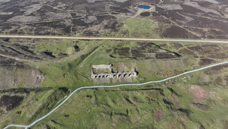 Rosedale-Abbey-Iron-Calcining-Kilns,-Aerial-Footage,-North-York-moors-National-Park,-Aerial-decent-with-pan-upwards