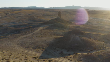 Smooth-Revealing-shot-of-an-isolated-pinnacle-in-the-desert-at-golden-hour
