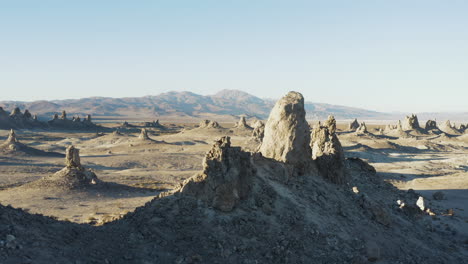 Smooth-descending-aerial-shot-of-the-Pinnacles-overlooking-a-range-of-mountains