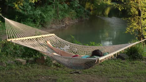 Girl-relaxing-in-a-hammock-by-the-Eleven-Point-River-in-Thomasville-Missouri