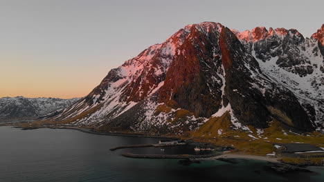 Aerial-View-Of-Marina-With-The-Rocky-Mountains-At-Sunrise-In-Eggum-Beach,-Norway