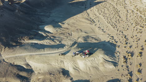 Aerial-pan-shot-of-a-camping-site-near-the-tufa-spires-in-the-california-desert