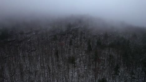 Aerial-drone-video-footage-of-a-foggy-nightf-in-the-snowy-Appalachian-mountains-during-winter,-in-the-Catskill-Mountains-sub-range