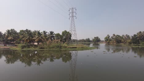 Scenic-Landscape-Waterway-With-Palm-Trees-And-Powerlines-In-Alappuzha-In-India