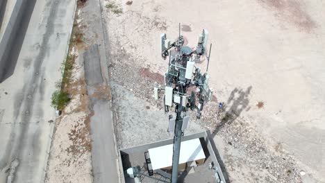 A-cellular-communications-tower---isolated-view-as-seen-descending-and-tilt-up-from-a-drone