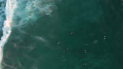 Surfers-And-Waves-In-Ocean-At-Llandudno,-Cape-Town---aerial-top-down