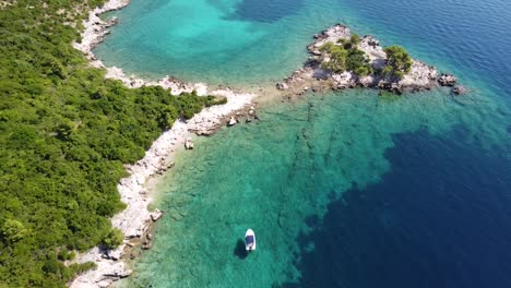 Aerial-Drone-View-a-Boat-Chilling-at-the-Turquoise,-Crystal-Clear-Adriatic-Sea-along-the-Coast-of-Dalmatia,-Croatia