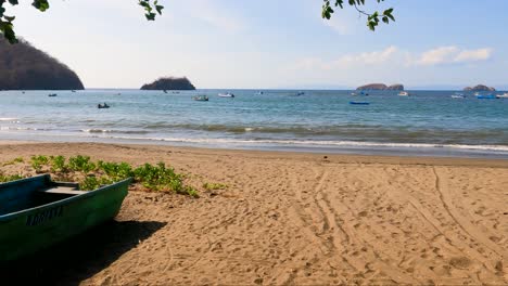 Bote-De-Madera-En-Una-Playa-Tropical-Con-Un-árbol-En-Un-Día-Soleado,-Playa-Coco-En-Guanacaste,-Costa-Rica