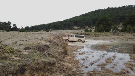 Old-Cream-Colored-Offroad-Car-Crossing-Puddle