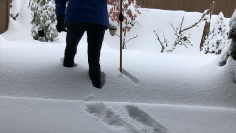 Woman-walking-in-deep-snow