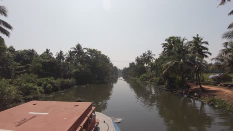 Traditional-Indian-Vessel-traveling-along-Jungle-water-canal,-Alleppey-or-Alappuzha,-Point-of-View