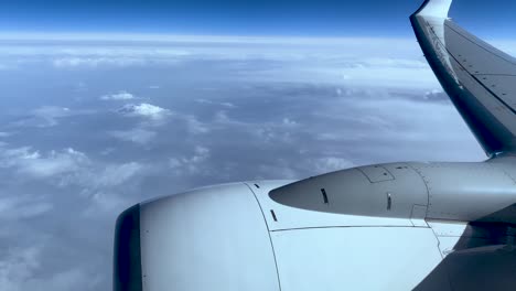 Aircraft-Engine-Flying-In-The-Sky-With-Fluffy-White-Clouds