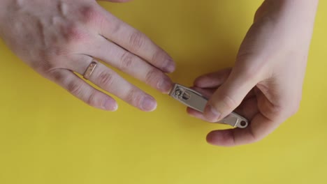 Clipping-nails-for-neat-trimmed-look-on-a-yellow-backdrop