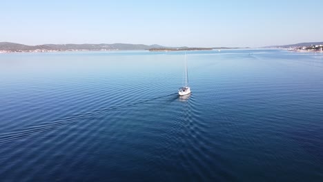 boat-floats-along-the-Coast-of-Biograd-na-Moru,-Dalmatia,-Croatia---Aerial-Drone-View