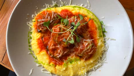Tasty-meatballs-with-creamy-polenta,-microgreens-and-cheese,-delicious-food-on-a-plate,-lunch-dinner,-4K-shot