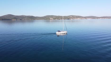 Sailboat-floats-along-the-Coast-of-Biograd-na-Moru-and-Tkon,-Dalmatia,-Croatia---Aerial-Drone-View
