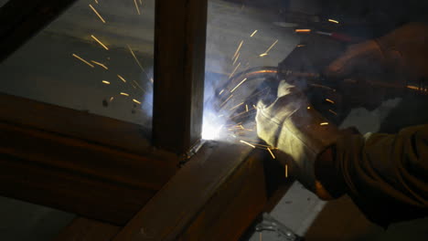 Sparks-fly-as-a-factory-worker-welds-steel-beams