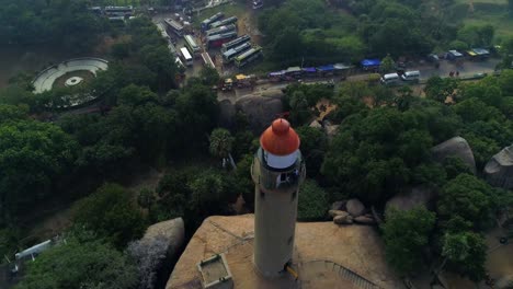 Light-house-of-mamallapuram-situated-among-famous-Rock-cut-Pallava-era-temples,-aerial-view-shot-on-Phantom-4-pro-4K-drone