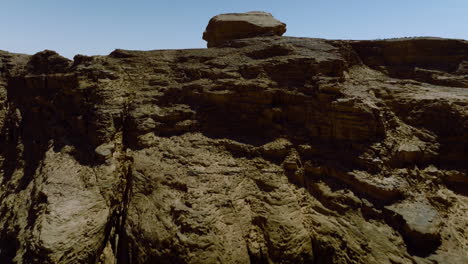 Flying-Over-Rock-Formation-Revealing-Arid-Landscape-Of-Wadi-Rum-In-Jordan