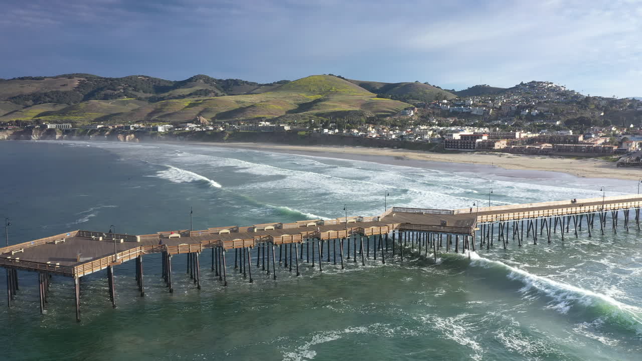 Premium stock video The famous pier at pismo beach sliding aerial