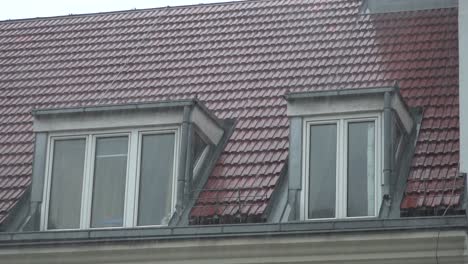 Regen-Fällt-Auf-Das-Städtische-Dach-Mit-Zwei-Fenstern-In-Zeitlupe