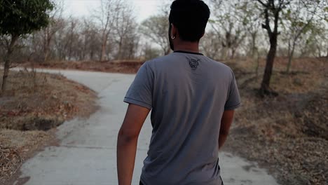 Backshot-of-an-Athletic-Young-Man-Walking-Towards-the-Road
