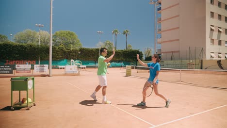 Tennis-coach-high-five-student-at-practice-and-get-ready-to-play