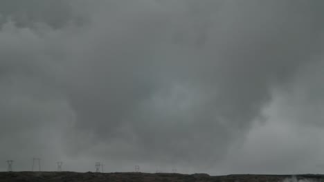 iceland-power-lines-and-smoking-pipe,-camera-movement,-camera-pan-from-right-to-left