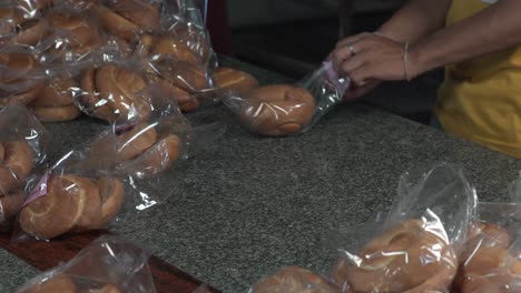 Packing-of-bread-and-and-labelling-them-in-a-plastic-bag-in-bakery