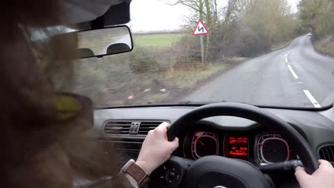 car-being-driven-along-country-road,-from-inside-car-in-the-UK