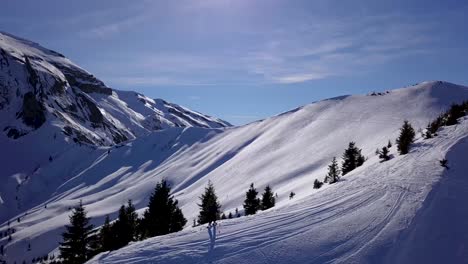 Drone-Following-Skiier-Skinning-On-Mountain-Ridge