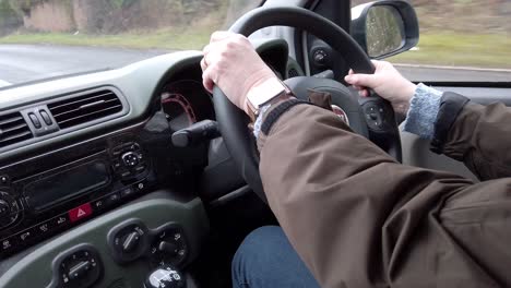 car-being-driven-along-country-road,-from-inside-car-in-the-UK