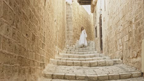 Girl-with-a-puffy-white-dress-going-down-the-stairs-gently