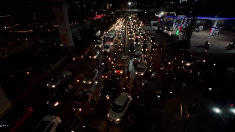 An-aerial-shot-of-night-traffic,-cars-on-highway-road-at-night-in-busy-city