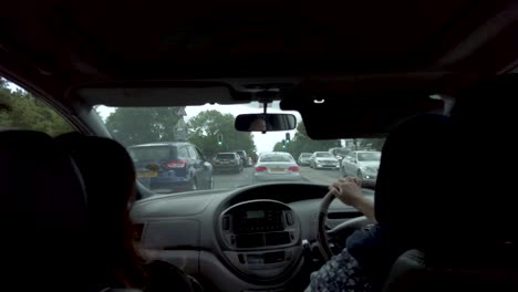 POV-View-Inside-Car-With-Women-Driving-Through-Slow-Moving-Traffic-In-London