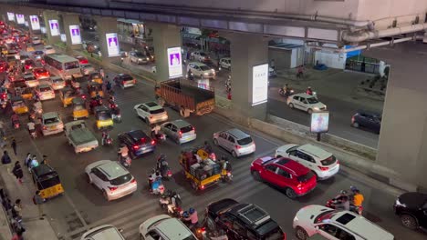 One-lane-is-filled-with-motorcycles-and-cars-of-various-colors-that-are-travelling-slowly,-while-on-the-other-lane-is-filled-with-vehicles-that-are-moving-at-normal-pace