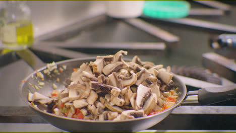 cooking-mushrooms-and-tomatoes-on-an-iron-pan