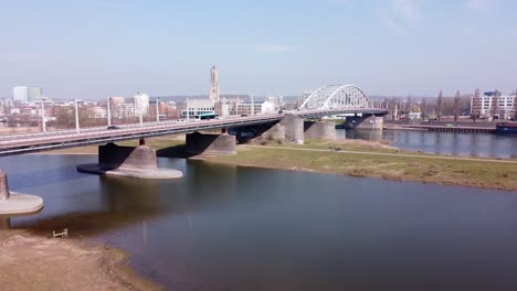 City-Skyline-and-Rhine-Bridge-in-Arnhem,-Gelderland,-Netherlands---Aerial