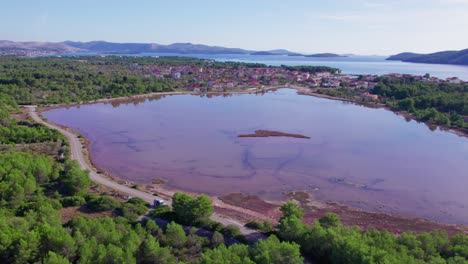 Beautiful-Mala-Solina-pink-lake-in-Croatia,-sunny-day,-aerial