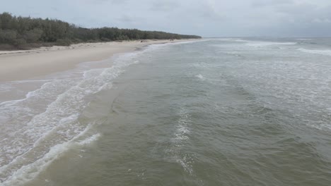 Lone-Woman-Swimming-In-Paradise-Beach-Of-North-Stradbroke-Island,-QLD-Australia
