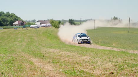 Car-coming-from-afar-in-a-dust-cloud---rally-car-drifting---slow-motion