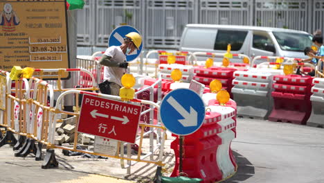 Roadworks-signs-on-a-street-repair-work-and-detour-arrow-for-pedestrian