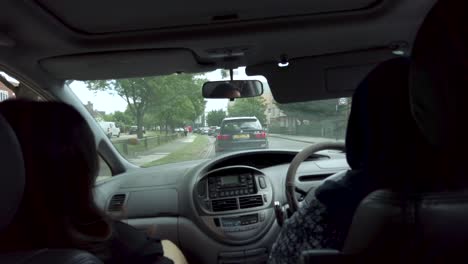 POV-View-Inside-Car-With-Muslim-Women-Driving-And-Talking-To-Passenger-Through-Slow-Traffic