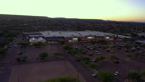 Drone-over-busy-Walmart-shopping-center-and-parking-lot-at-dusk