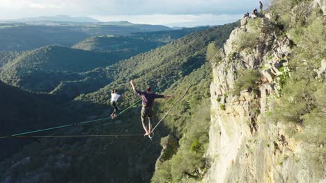 Performance-Of-Tightrope-Walkers-In-Nature---Highliners-On-The-Background-Of-Valley---aerial-shot