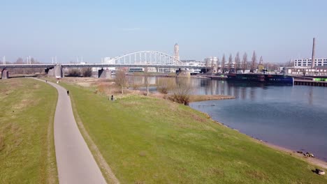 City-Skyline-and-Rhine-Bridge-in-Arnhem,-Gelderland,-Netherlands---Aerial